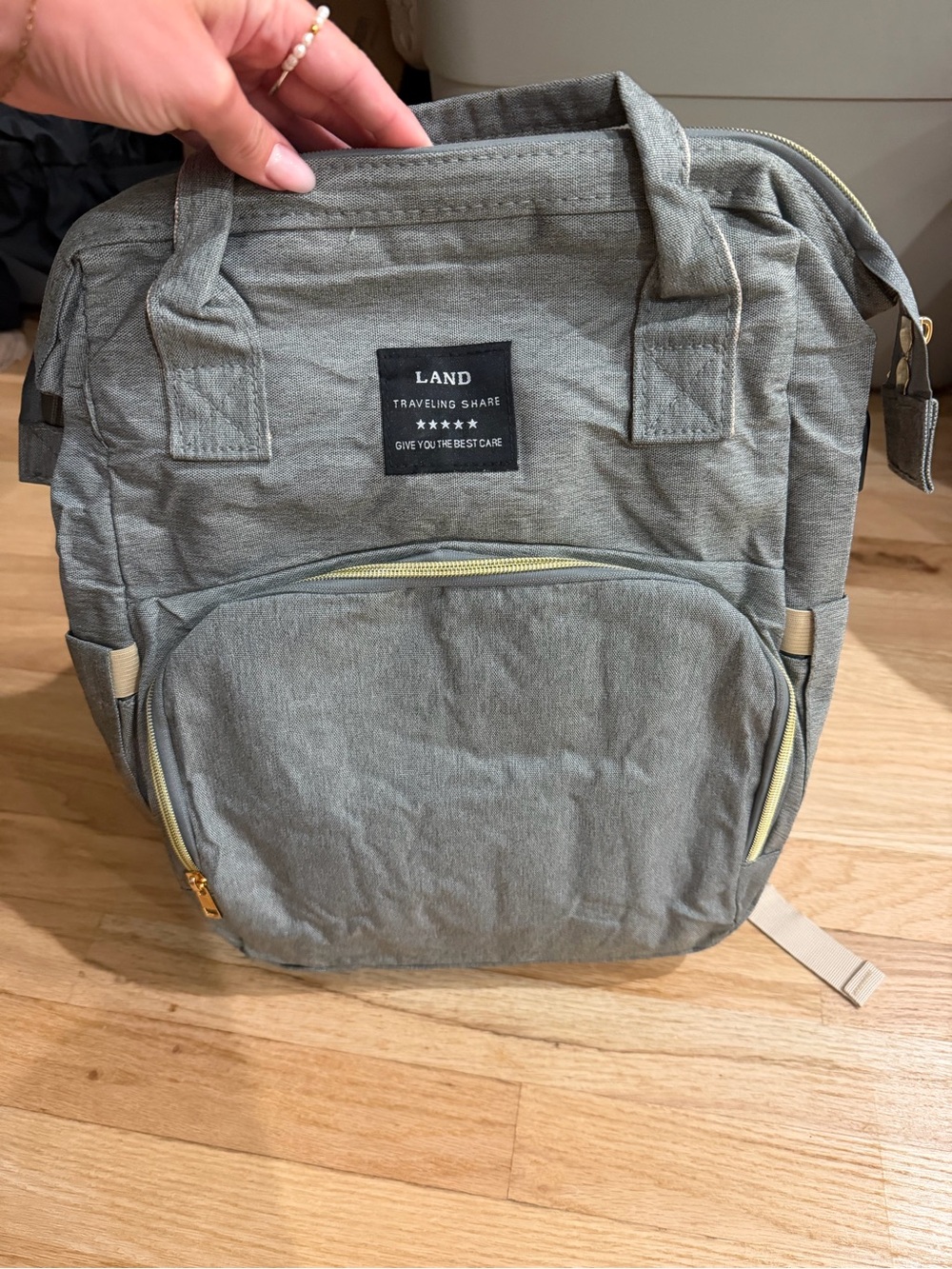 Gray Baby Diaper Backpack with Gold Zipper Accents